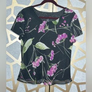 Boat neck, flair on bottom of top. Shear floral overlay on poke-a-dot underlay